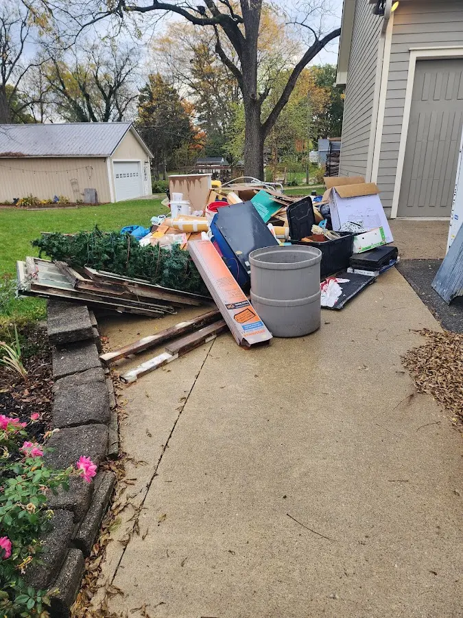 Dumpster being loaded with debris for 12 Yard Dumpster Rental in Malmstrom AFB